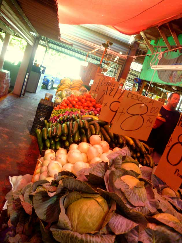Cabbages, white onions, cucumbers and tomatoes on display at Los Globos open air markets in Ensenada, Baja California Norte, Mexico.